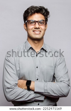 Formal business male portrait. Confident successful Indian businessman or manager, in shirt, stands in the studio background with arms crossed, looks directly at camera and smiles friendly.
 Royalty-Free Stock Photo #2252971169