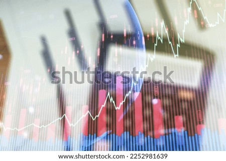 Abstract creative financial graph and world map on blurry calculator and papers background, financial and trading concept. Multiexposure