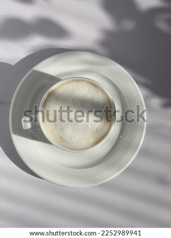 The cup of hot coffee with milk foam 