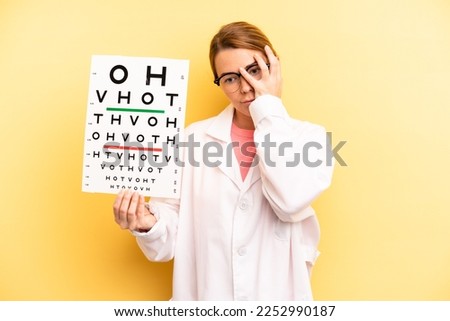 pretty blonde young woman feeling bored, frustrated and sleepy after a tiresome. optical vision test concept