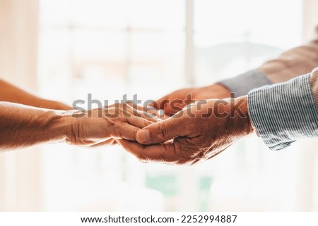 Close up elderly affectionate woman covering wrinkled hands of mature husband, showing love and support at home. Caring middle aged family couple enjoying sincere trustful honest conversation. Royalty-Free Stock Photo #2252994887