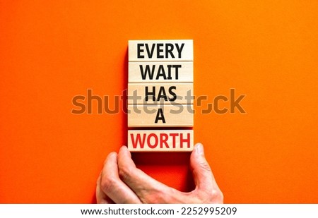 Every wait has a worth symbol. Concept words Every wait has a worth on wooden blocks. Beautiful orange table orange background. Businessman hand. Business Every wait has a worth concept. Copy space.