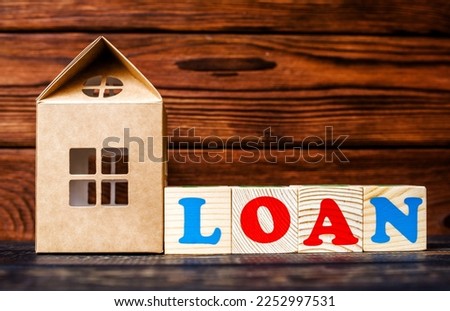 Wooden home and text on the cubes loan