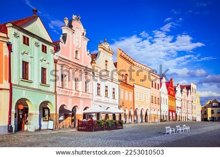 Telc, Czech Republic. Main Hradce Square of Telc with its famous 16th-century colorful houses, a UNESCO World Heritage Site, on a sunny day with blue sky and clouds, historical Moravia. Royalty-Free Stock Photo #2253010503