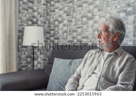 Face of senior caucasian hoary man looking away deep in sad thoughts feels lonely close up portrait, recollect memories and life moments, depressed grandfather alone indoors, yearning for wife concept Royalty-Free Stock Photo #2253015963