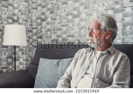 Face of senior caucasian hoary man looking away deep in sad thoughts feels lonely close up portrait, recollect memories and life moments, depressed grandfather alone indoors, yearning for wife concept Royalty-Free Stock Photo #2253015969