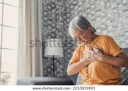 Upset stressed mature middle aged woman feeling pain ache touching chest having heart attack, sad worried senior older lady suffers from heartache at home, infarction or female heart disease concept Royalty-Free Stock Photo #2253019801