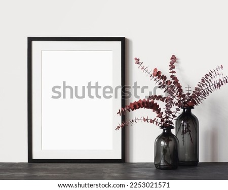 Blank picture frame mockup on a wall. Vertical orientation. Artwork template in interior design