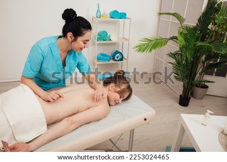female masseur does therapeutic spa massage
