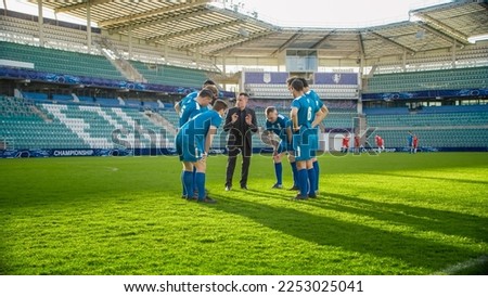 Soccer Team Training on Stadium: Coach Calls Players to Discuss Football Game Strategy and Tactics. Trainer Leads Athletes to Victory, Preparing For Championship, Encouraging Sportsmen. Workout Plan Royalty-Free Stock Photo #2253025041