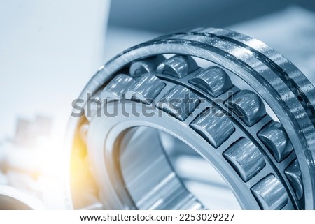 The cylindrical rolling bearing parts in light blue scene. The heavy mechanical part manufacturing concept. Royalty-Free Stock Photo #2253029227