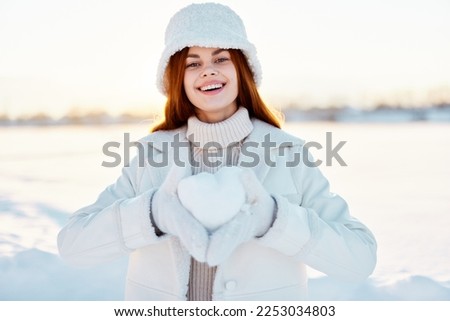 woman smile Winter mood walk white coat snow in the hands travel