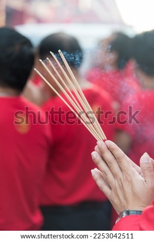 Pay respect to god by lighting up incense sticks Royalty-Free Stock Photo #2253042511