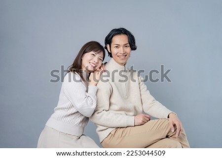 Asian couple wearing matching clothes in natural colors. Couple photo. Bridal photo.