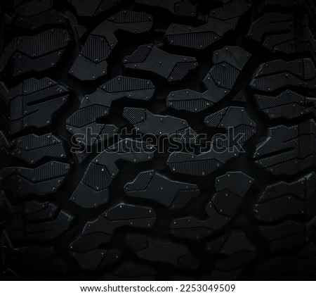 Close up picture of brand new black automobile Tyre texture on black background. Tread for crossovers and SUVs, off-road tires.	                         