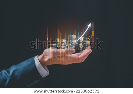 investment and finance concept, businessman holding virtual trading graph and blurred coins on hand, stock market, profits and business growth. Royalty-Free Stock Photo #2253062391