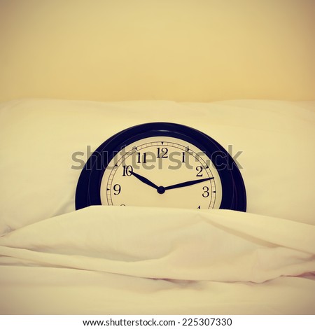 picture of a clock inside a bed, with a retro effect