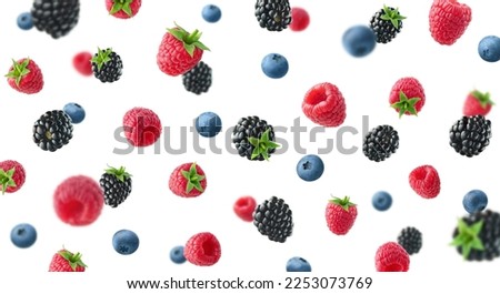 Collection of various falling fresh ripe wild berries isolated on white background. Raspberry, blackberry and blueberry from different angles Royalty-Free Stock Photo #2253073769