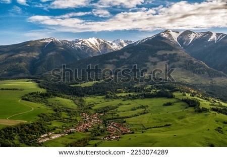 Beautiful view of Western Tatras mountains in Slovakia. Village Jakubovany and Konska under and peak Baranec at background. Green landscape and hills. Aerial drone photography.