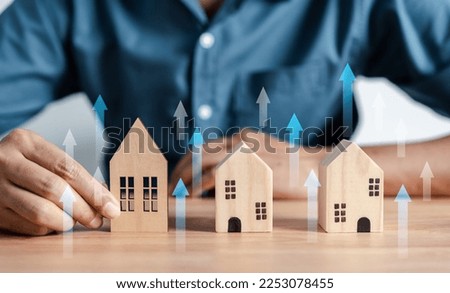 Increased value of real estate. Businessman owner home investment planning real estate business income earning profit Investor thinking strategy. Royalty-Free Stock Photo #2253078455
