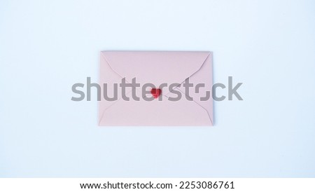 Pink paper envelope with Valentines hearts on white background. Flat lay, top view. Romantic love letter for Valentine's day concept.                                Royalty-Free Stock Photo #2253086761