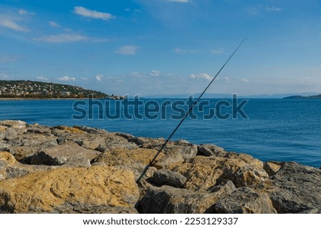 Fishing tackle, fishermen and fishing rods in the sea.