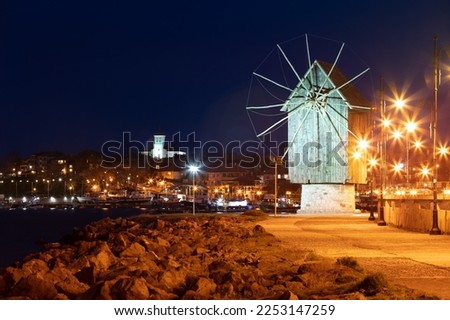 Illuminated evening view of Old Town of Nessebar with old wooden windmill. Splendid spring scene of Bulgaria, Europe. Traveling concept background.