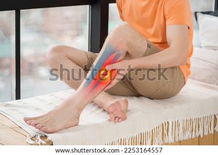 Broken leg, man suffering from pain at home, bone fracture with displacement, health problems concept Royalty-Free Stock Photo #2253164557