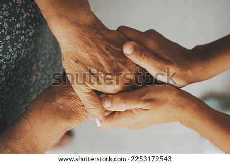 Caring elderly grandma wife holding hand supporting senior grandpa husband give empathy care love, old married grandparents couple together two man and woman hope understanding concept, close up view Royalty-Free Stock Photo #2253179543