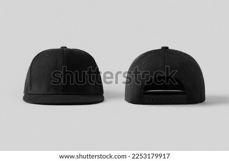 Black snapback caps mockup on a grey background, front and back side. Royalty-Free Stock Photo #2253179917