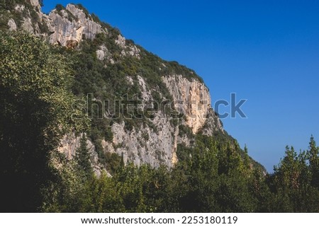 View of hiking trail from Paleokastritsa to Lakones, Old Donkey path, Corfu, Kerkyra, Greece, Ionian sea islands, with olive grove forest and mountains, in summer sunny day, trekking on Corfu
