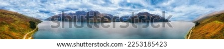 Wide aerial panorama of Lake Wakatipu in Otago of New Zealand South island near Queenstown - scenic mountain landscape.