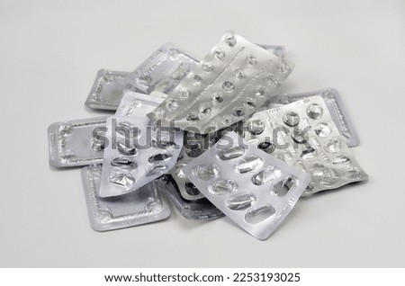 used packs of pills close-up on a white background