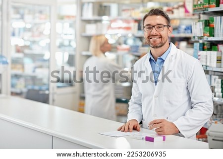 Portrait of happy pharmacist man with pharmacy services, medicine advice and product trust at shop, retail counter. Inventory, stock help desk and medical professional worker, person or doctor smile Royalty-Free Stock Photo #2253206935