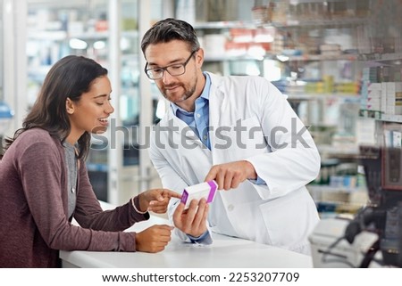 Healthcare service and pharmacy worker with customer at store counter for medication explanation. Pharmaceutical advice and opinion of pharmacist helping girl with medicine information. Royalty-Free Stock Photo #2253207709