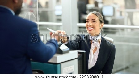 Airport, passport and travel with a woman passenger assistant helping a business man traveller with check in. Security, immigration or documents with a female working in a terminal for border control Royalty-Free Stock Photo #2253208011