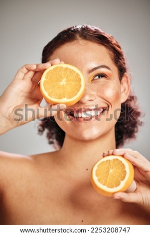Orange, beauty and woman face in studio with a smile for natural skin glow, cosmetic and dermatology. Facial results, health and wellness of aesthetic model person happy with vitamin c fruit idea Royalty-Free Stock Photo #2253208747