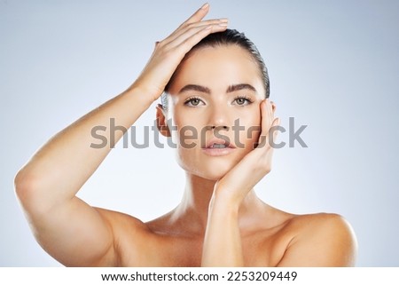 Beauty, skincare cosmetics and portrait of a woman isolated on a grey studio background. Glow, clean and face of a spa dermatology model with facial health, hydration and wellness on a backdrop Royalty-Free Stock Photo #2253209449