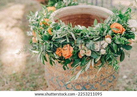 A font decorated with flowers for a child's christening in Greece. preparation for the rite of Orthodox baptism Royalty-Free Stock Photo #2253211095