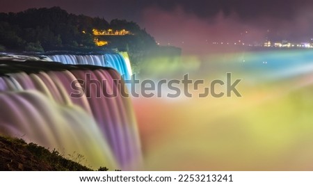 Every evening beginning at dusk, American and Canadian Horseshoe Falls (Niagara Falls) is transformed into an incredible, multi-colored water and light masterpiece.  Royalty-Free Stock Photo #2253213241