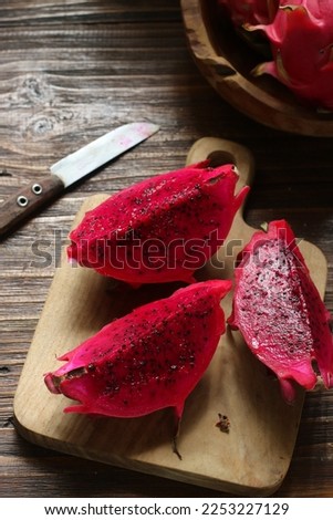 Fresh Sliced Red Dragon Fruit. Glowing and Blurry Look on a Surface. Moody Dark Photography. 