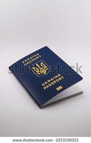 Foreign passport of a citizen of Ukraine, emblem with gold embossing, blue color, photo on a white background, with daylight for a good picture, for travel abroad, for interesting travels.