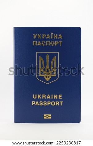 Foreign passport of a citizen of Ukraine, emblem with gold embossing, blue color, photo on a white background, with daylight for a good picture, for travel abroad, for interesting travels.
