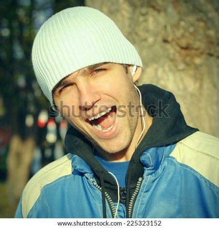 Toned photo of Cheerful Young Man Portrait outdoor