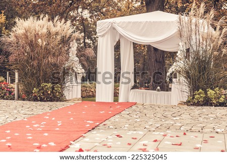 path to wedding ceremony marquee with petals, vintage picture