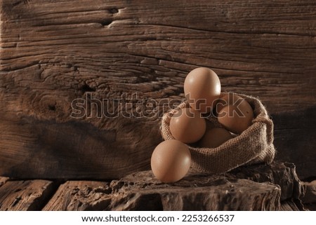 chicken eggs in burlap sack rustic wooden background there is free space for your content writing.