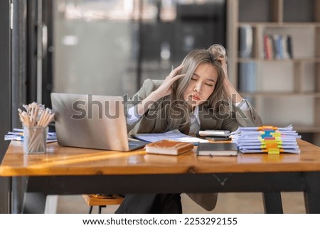 Bored Young business Asian woman sitting at her workplace at the office esk for a long time, Work mental health feel boring and Lazy, Freelance employees sleeping lying, Stress concept.