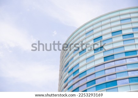 facade of a modern building covered in reflective plates and glass. Modern glass facade office building.hub for media, entertainment and IT industry. geometric pattern.copy space