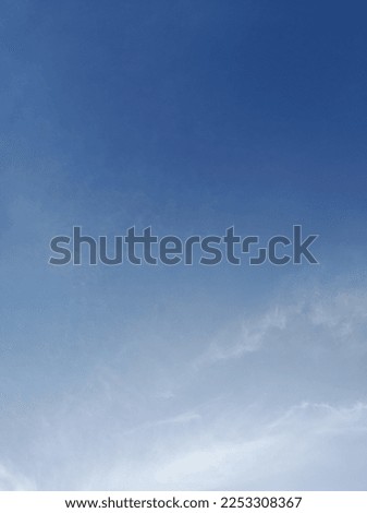 White clouds in the blue sky. Beautiful bright blue background. Light cloudy, good weather. Curly clouds on a sunny day.
