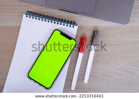 Mobile phone chroma key display. Laptop technology. High quality top view photo with smartphone. Online banking, application, empty space for logo, emblem. Mock up